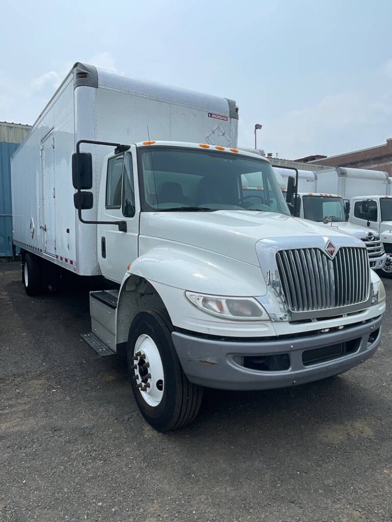 a white large truck in a parking area